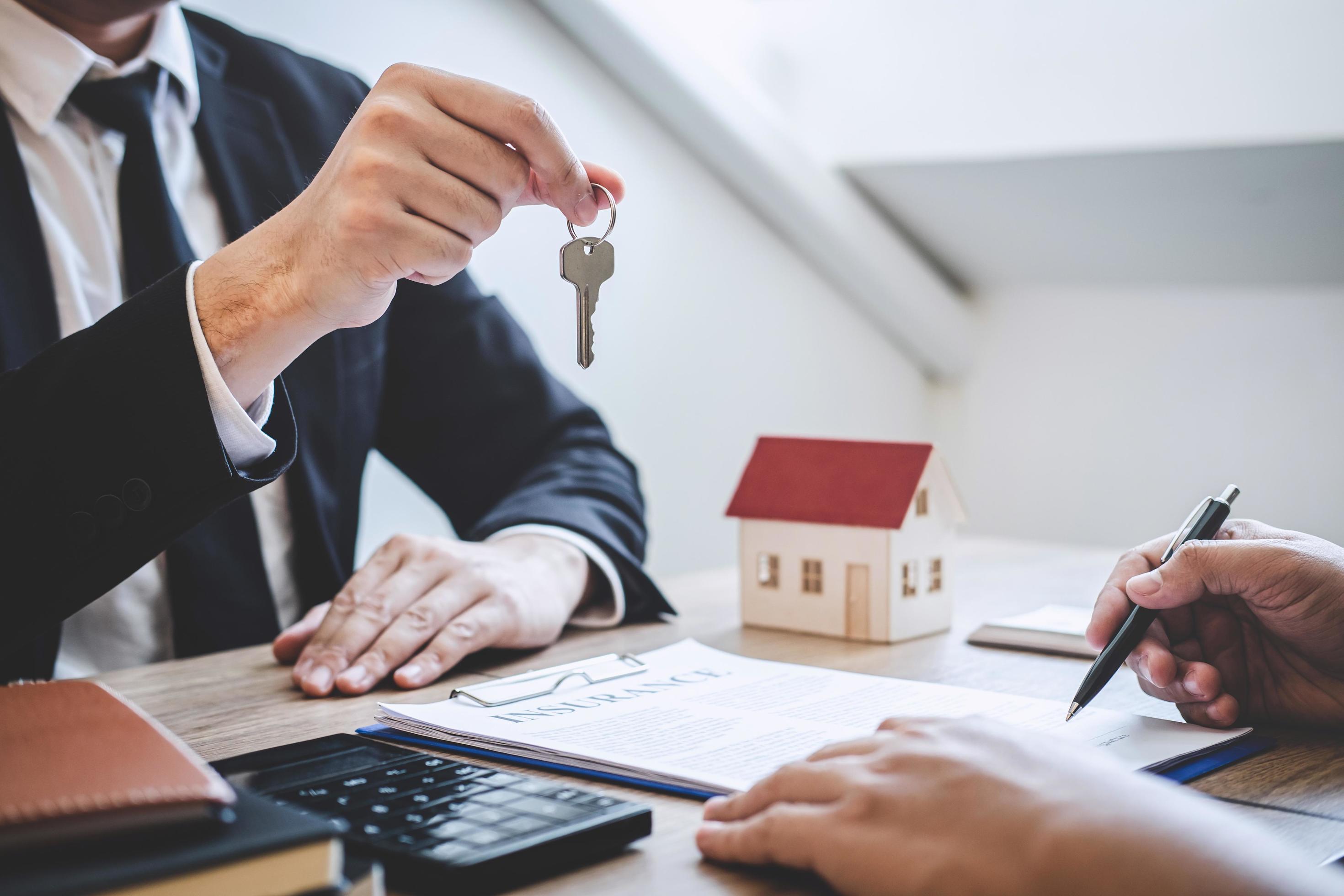 Estate agent giving house keys to client 1226859 Stock Photo at Vecteezy